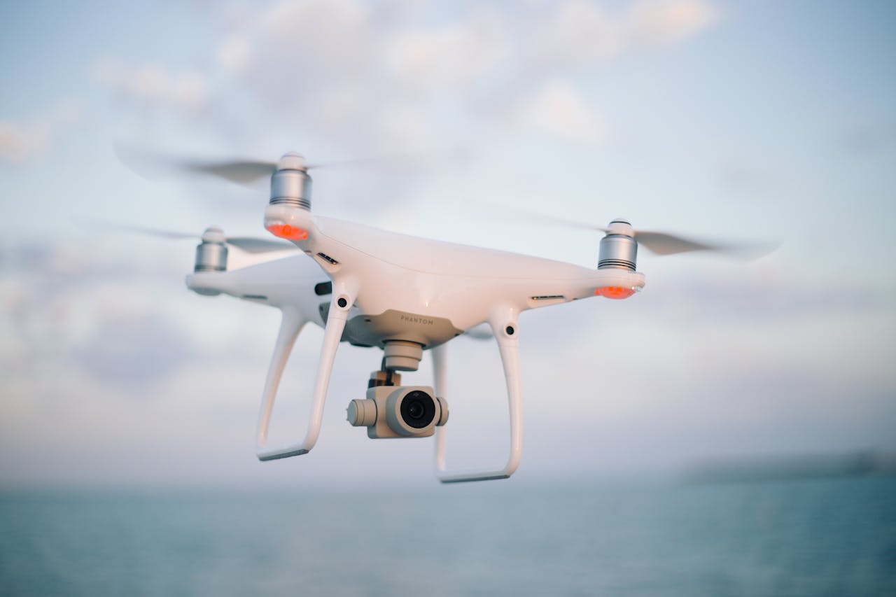 Aerial view of a modern drone flying above the ocean during the day.